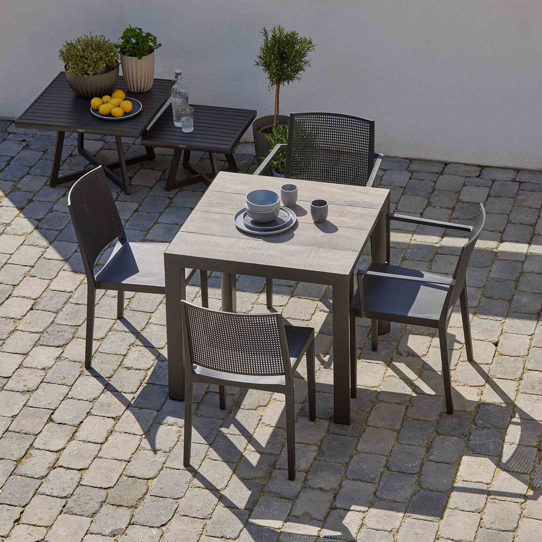Stabelstol ute Square plast antrasitt 54x56 cm i bruk på terrasse